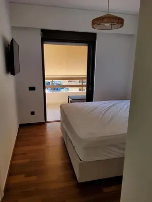 a bedroom with a bed and a sliding glass door at Elizabeth's in Athens
