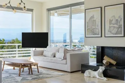 a living room with a couch and a fireplace at 3 Bedroom Apartment in Glyfada in Athens