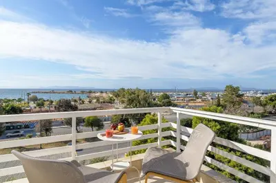 a balcony with two chairs and a table and a view at 3 Bedroom Apartment in Glyfada in Athens