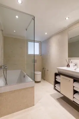a bathroom with a tub and a sink at 3 Bedroom Apartment in Glyfada in Athens