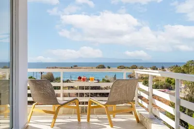 two chairs on a balcony with a view of the ocean at 3 Bedroom Apartment in Glyfada in Athens