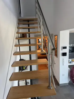 a staircase in a house with wooden treads at The Artist House - Best Sea View in Porto Rafti in Porto Rafti