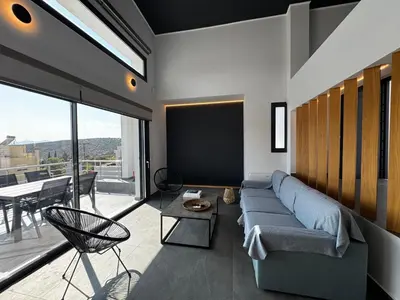 a living room with a couch and a large window at The Artist House - Best Sea View in Porto Rafti in Porto Rafti