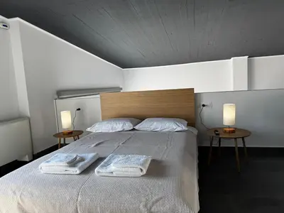 a bedroom with a bed with two towels on it at The Artist House - Best Sea View in Porto Rafti in Porto Rafti