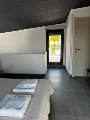 a bedroom with a bed with two towels on it at The Artist House - Best Sea View in Porto Rafti in Porto Rafti