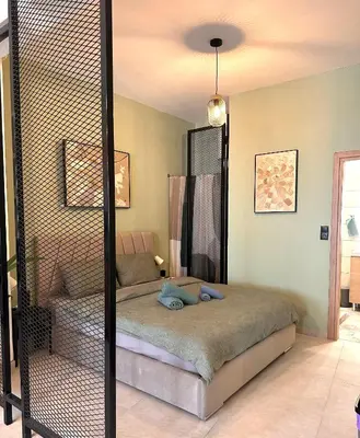 a bedroom with a bed in a room at National Garden and Panathenaic Stadium area Moden Cozy Studio A in Athens