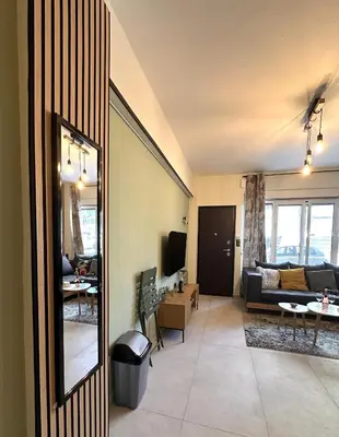 a living room with a couch and a table at National Garden and Panathenaic Stadium area Moden Cozy Studio A in Athens