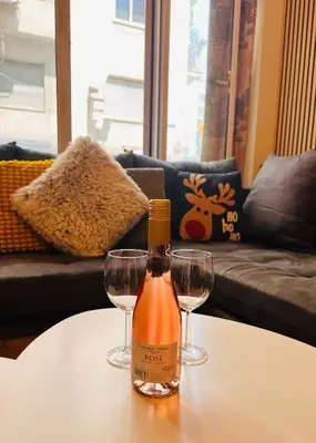 a bottle of wine sitting on a table with two glasses at National Garden and Panathenaic Stadium area Moden Cozy Studio A in Athens