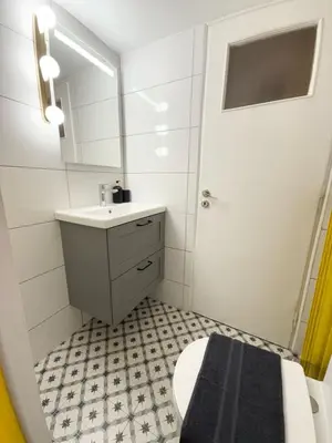 a bathroom with a sink and a toilet and a mirror at Kipseli Comfort Apartment in Athens