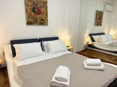 a bedroom with a large bed with two towels on it at Kipseli Comfort Apartment in Athens