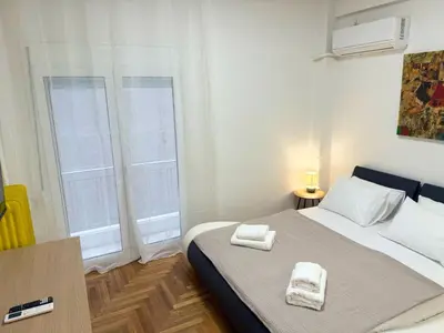a bedroom with a bed with two towels on it at Kipseli Comfort Apartment in Athens