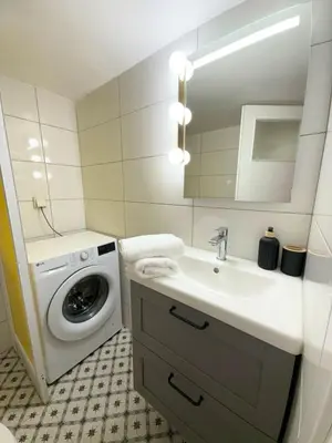 a bathroom with a washing machine and a sink at Kipseli Comfort Apartment in Athens