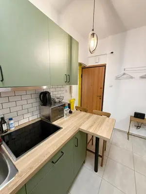 a kitchen with green cabinets and a wooden counter top at Kipseli Comfort Apartment in Athens
