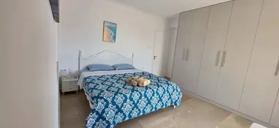 a bedroom with a bed with a teddy bear on it at Helen's holiday home in Athens