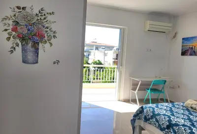 a room with a vase of flowers on the wall at Helen's holiday home in Athens