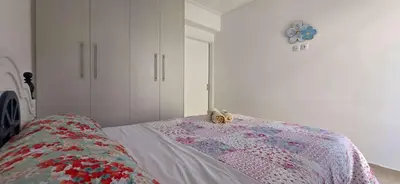 a bedroom with a bed and a clock on the wall at Helen's holiday home in Athens