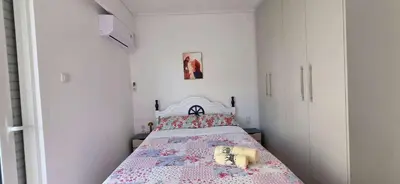 a bedroom with a bed with a pink bedspread at Helen's holiday home in Athens