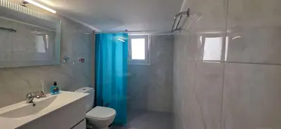 a bathroom with a shower and a toilet and a sink at Helen's holiday home in Athens