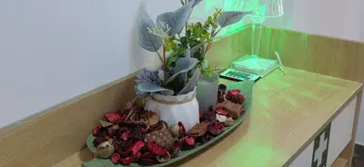 a vase on a table with flowers and cookies at Helen's holiday home in Athens