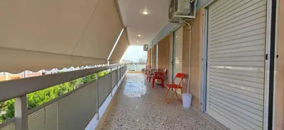 a balcony with chairs and a table on it at Helen's holiday home in Athens