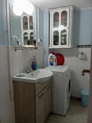 a bathroom with a sink and a washing machine at Comfort bed in a room 5' from metro in Athens