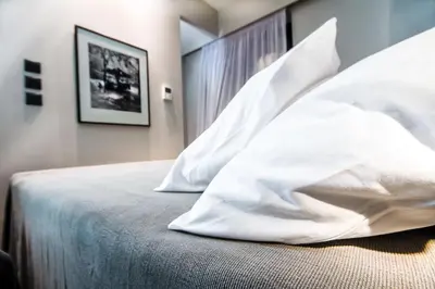 a bedroom with white pillows on a bed at Comfort studio in Kolonaki 2 in Athens