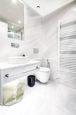 a white bathroom with a sink and a toilet at Comfort studio in Kolonaki 2 in Athens
