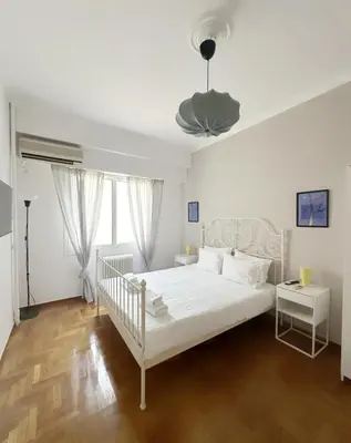 a bedroom with a white bed and a white ceiling at Acropolis Nest in Athens