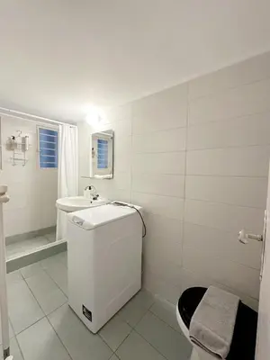 a white bathroom with a toilet and a sink at Acropolis Nest in Athens