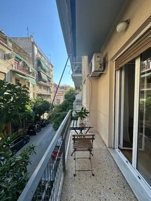 a balcony with a bench on the side of a building at Acropolis Nest in Athens