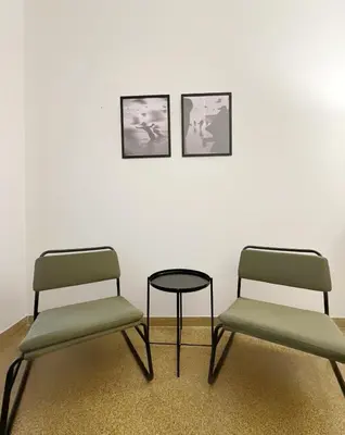 two chairs and a table in front of a wall at Acropolis Nest in Athens