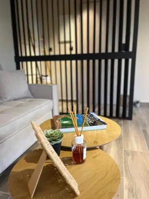 a coffee table with a book and chopsticks on it at Χenion Inn - Athens Airport, Easy Check In Anytime in Markopoulo