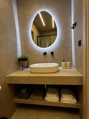 a bathroom with a sink and a mirror at Χenion Inn - Athens Airport, Easy Check In Anytime in Markopoulo