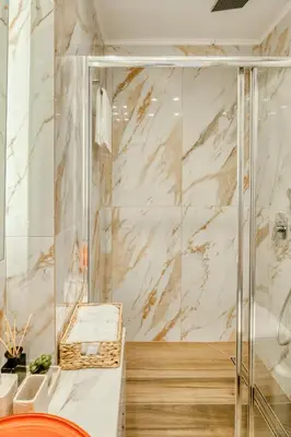 a bathroom with a shower with a glass door at Ayla Studio Athens in Athens