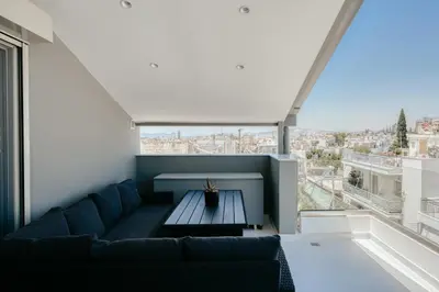 a living room with a couch and a large window at Ayla Studio Athens in Athens