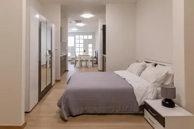 a bedroom with a large bed and a bathroom at Urban Athens - Studio #1 in Athens