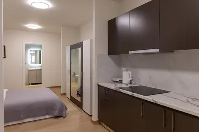 a kitchen with a sink and a bed in a room at Urban Athens - Studio #1 in Athens
