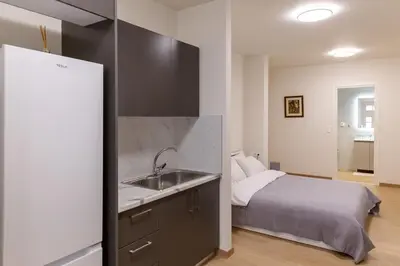 a kitchen with a sink and a bed in a room at Urban Athens - Studio #1 in Athens