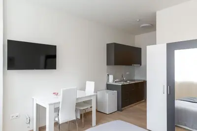 a white room with a white table and white chairs at Urban Athens - Studio #3 in Athens