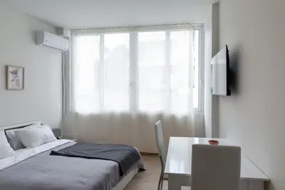 a bedroom with a bed and a table and a window at Urban Athens - Studio #3 in Athens