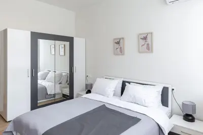 a bedroom with a large bed and a mirror at Urban Athens - Studio #3 in Athens
