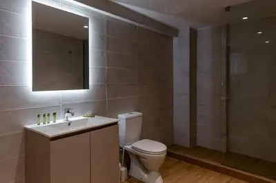 a bathroom with a toilet and a sink and a mirror at Urban Athens - Studio #4 in Athens