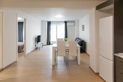 a kitchen and living room with a table and chairs at Urban Athens - One Bedroom in Athens