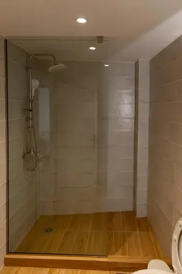 a shower with a glass door in a bathroom at Urban Athens - One Bedroom in Athens