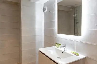 a bathroom with a sink and a mirror at Urban Athens - One Bedroom in Athens