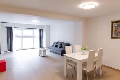 a living room with a table and a couch at Urban Athens - One Bedroom in Athens