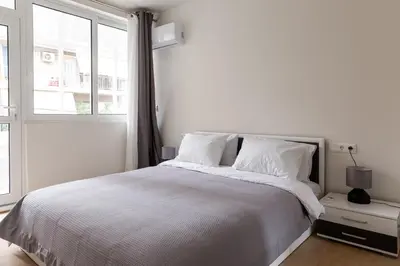 a white bedroom with a bed and a window at Urban Athens - Two Bedroom #7 in Athens