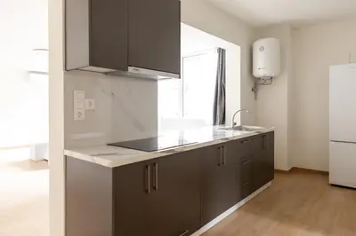 a kitchen with gray cabinets and a sink and a window at Urban Athens - Two Bedroom #7 in Athens