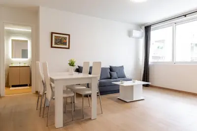 a living room with a table and a couch at Urban Athens - One Bedroom #8 in Athens
