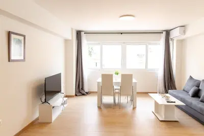 a living room with a table and a couch at Urban Athens - Two Bedroom #9 in Athens